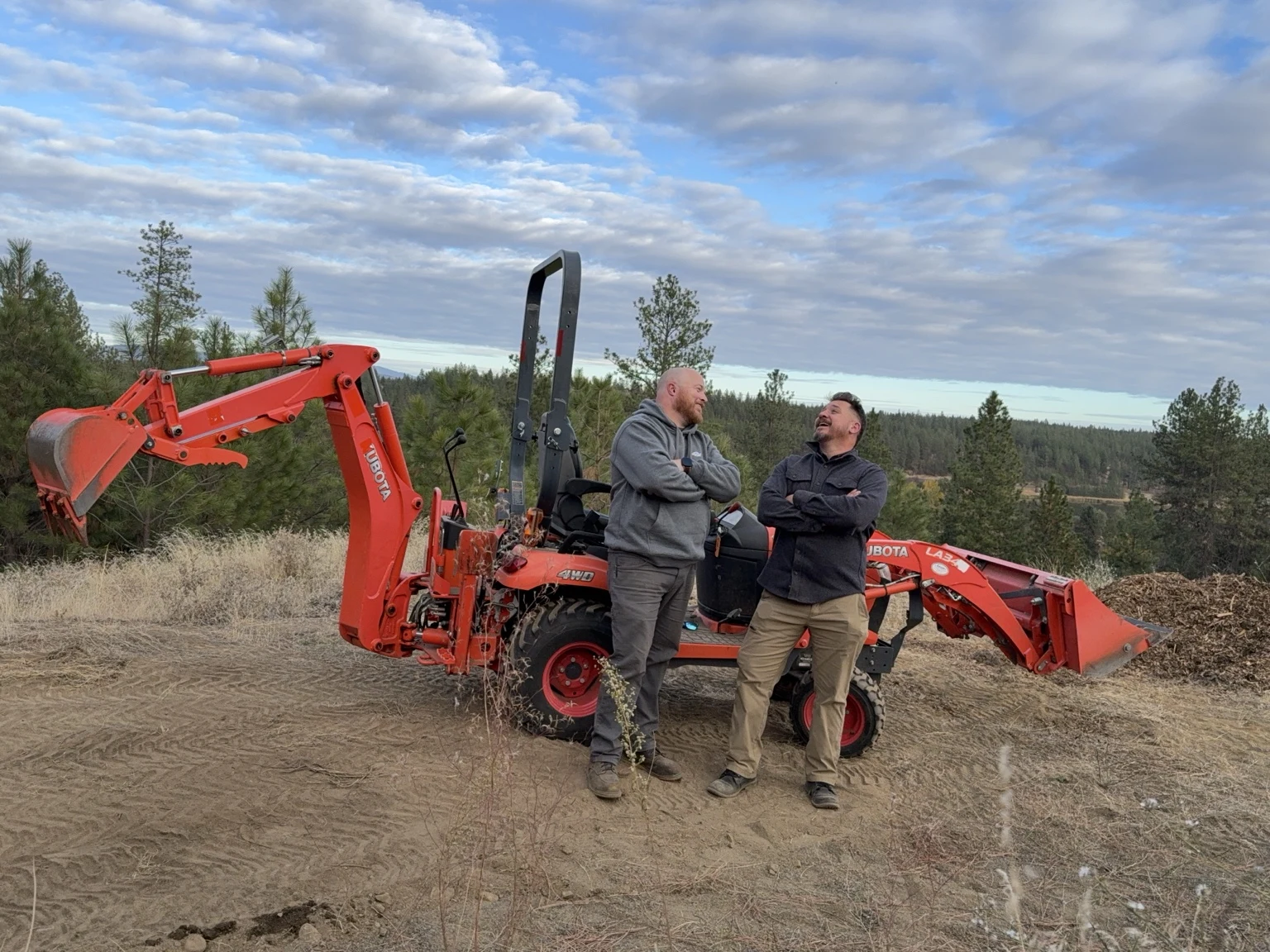 Chris and Iaian sharing a laugh beside their tractor